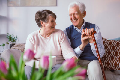 Senior,Happy,Couple,Sitting,Together,On,A,Couch,In,A